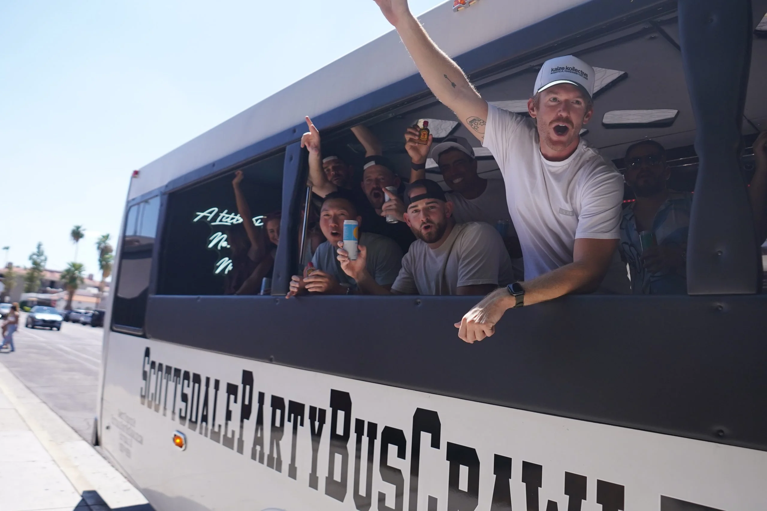 Friends yelling out white party bus crawler